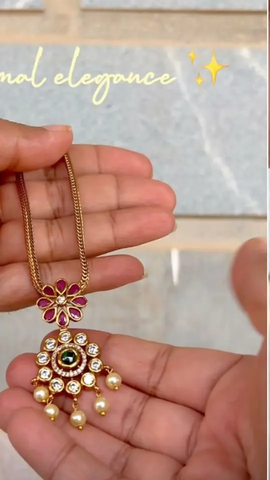 Ruby flower pendant on a gold chain